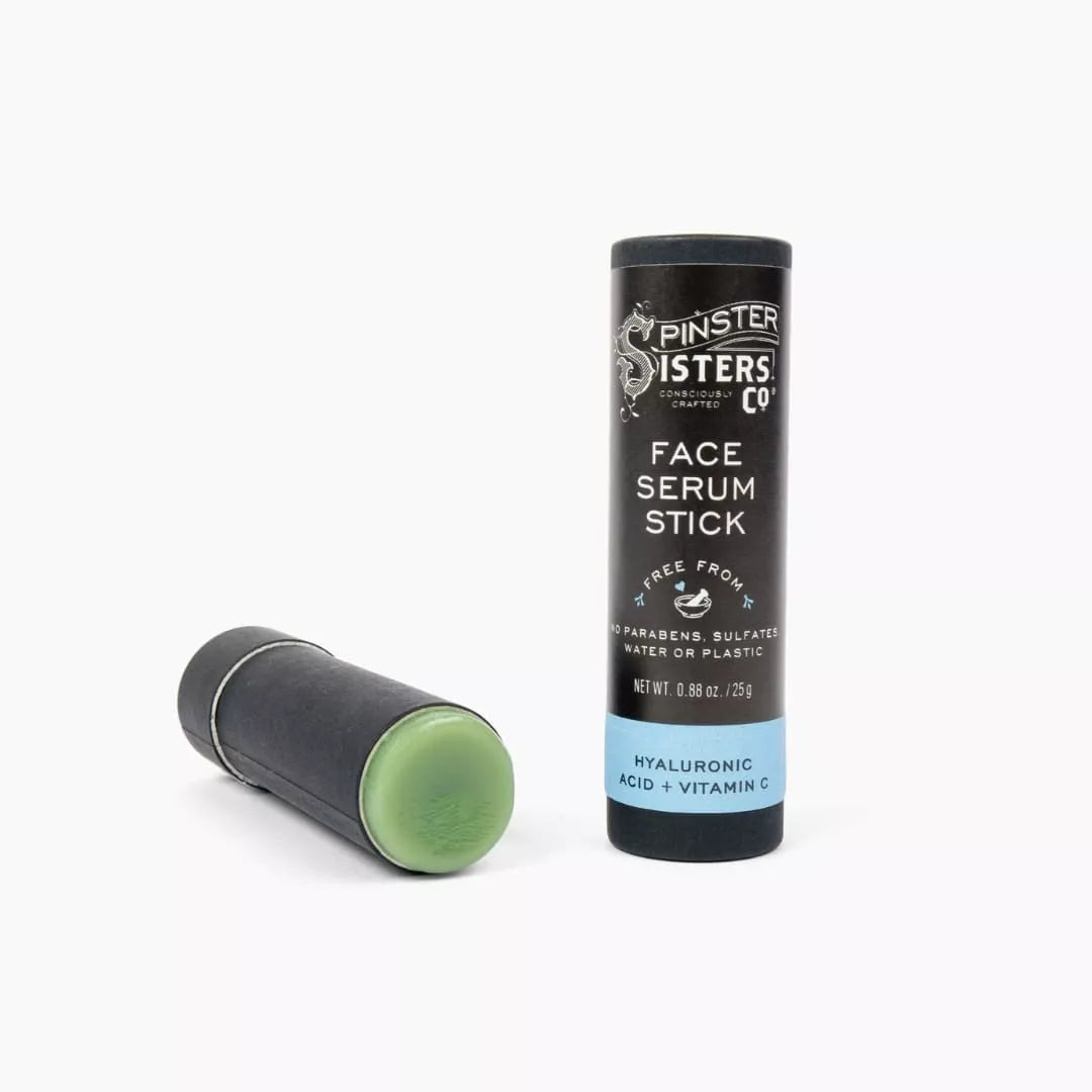 Spinster Sisters Face Serum Stick with hyaluronic acid and vitamin C, showing the portable skincare product with clear branding.