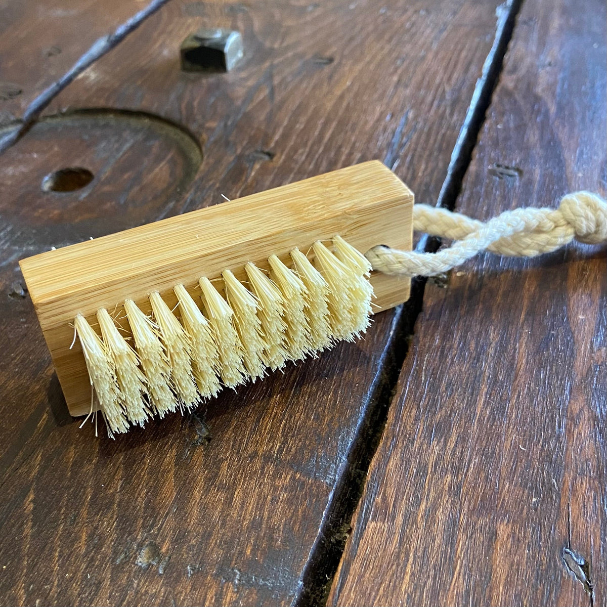 OTB Refills bamboo nail brush and small scrubber with natural wooden handle and soft bristles for gentle nail cleaning.