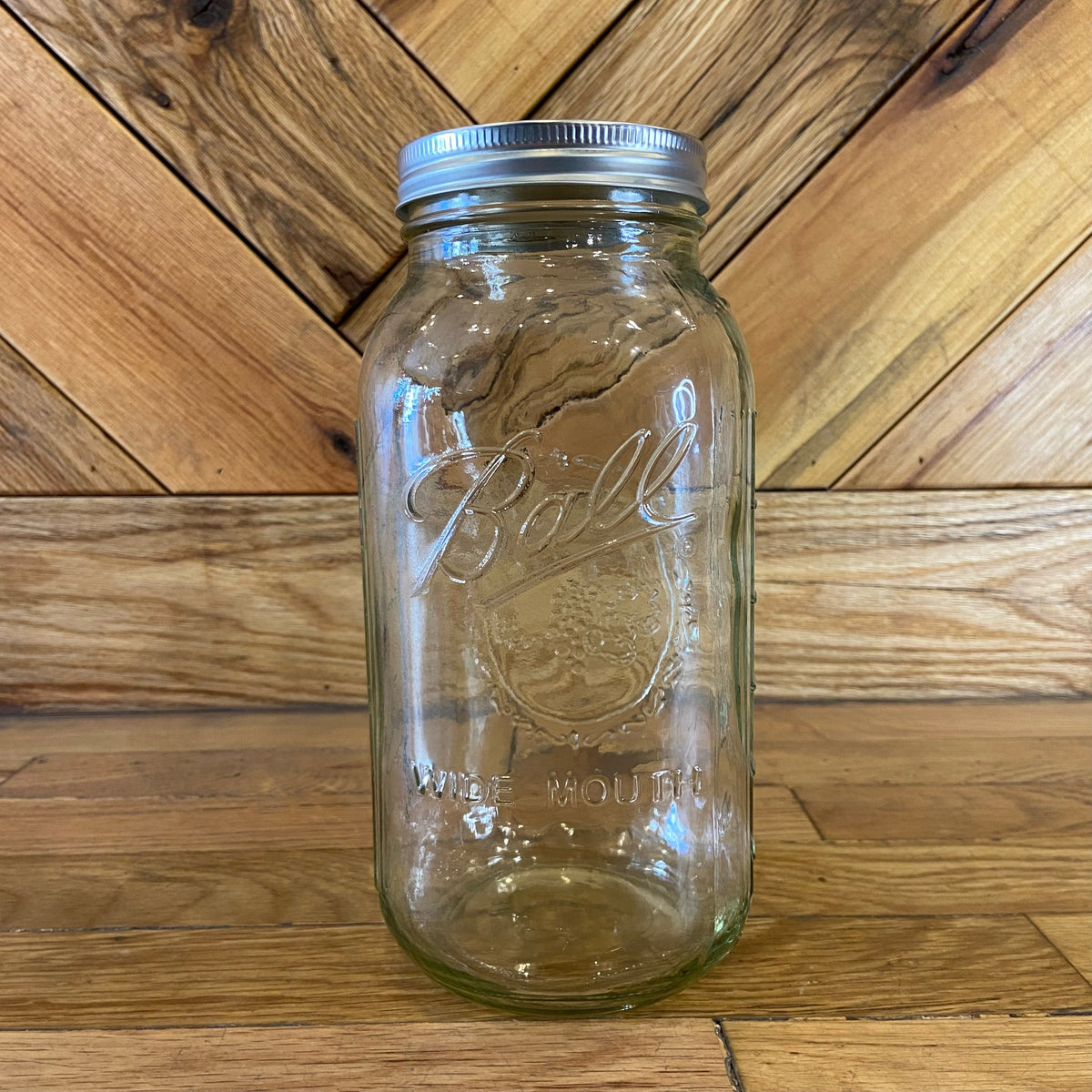 Large 64oz Ball Mason glass jar with metal screw lid, ideal for storage and canning.