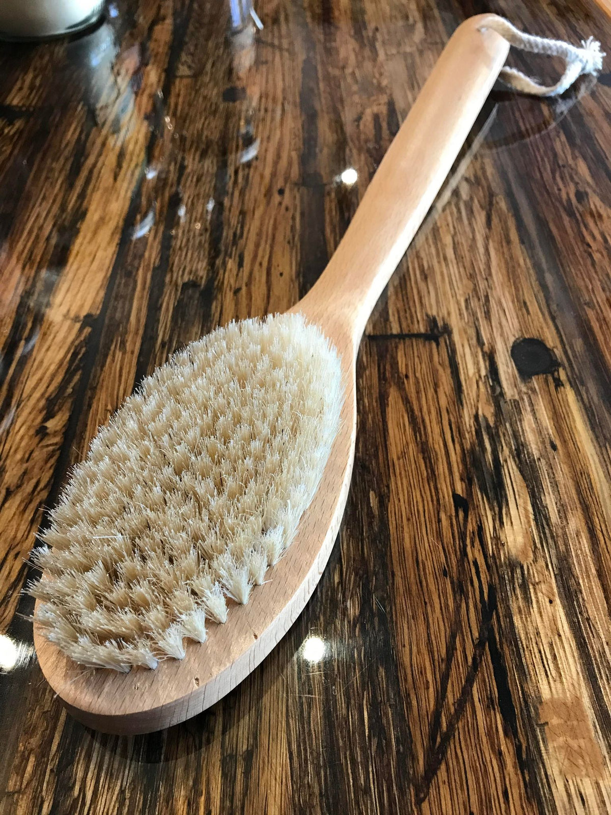 OTB Refills long handle bath and back scrub brush with ergonomic grip for effective cleansing and exfoliation.