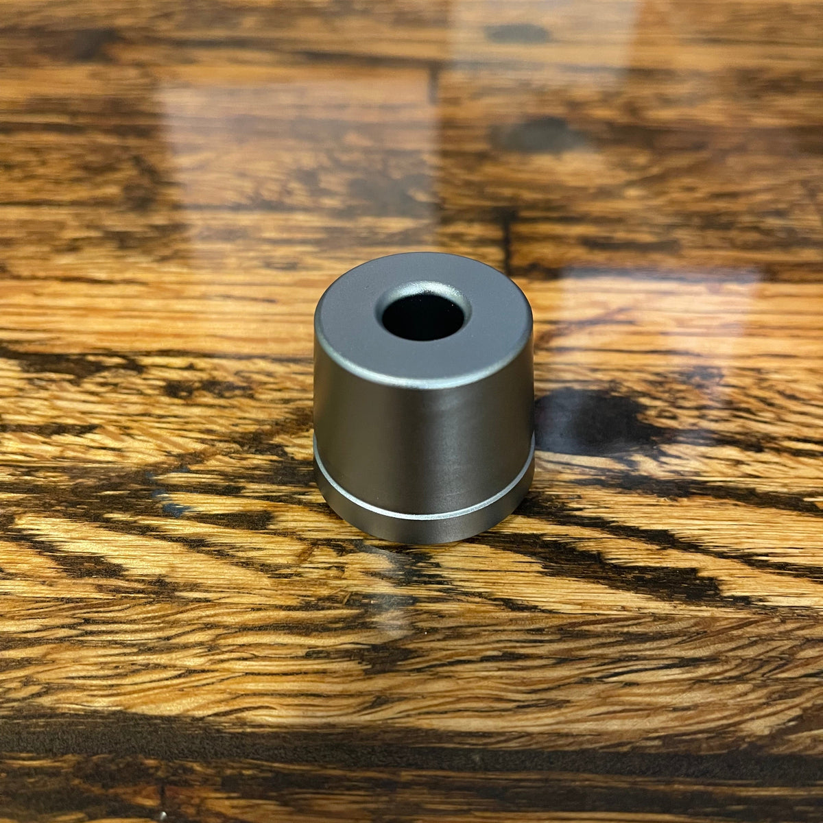 Metal razor stand by Ningbo Haward Razor holding a safety razor and shaving brush on a clean surface.