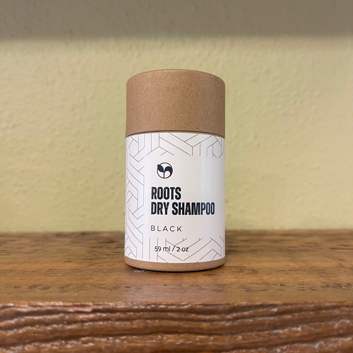ScentCerae Natural Roots Dry Shampoo 2oz shaker with white and clear container and black cap on a white background