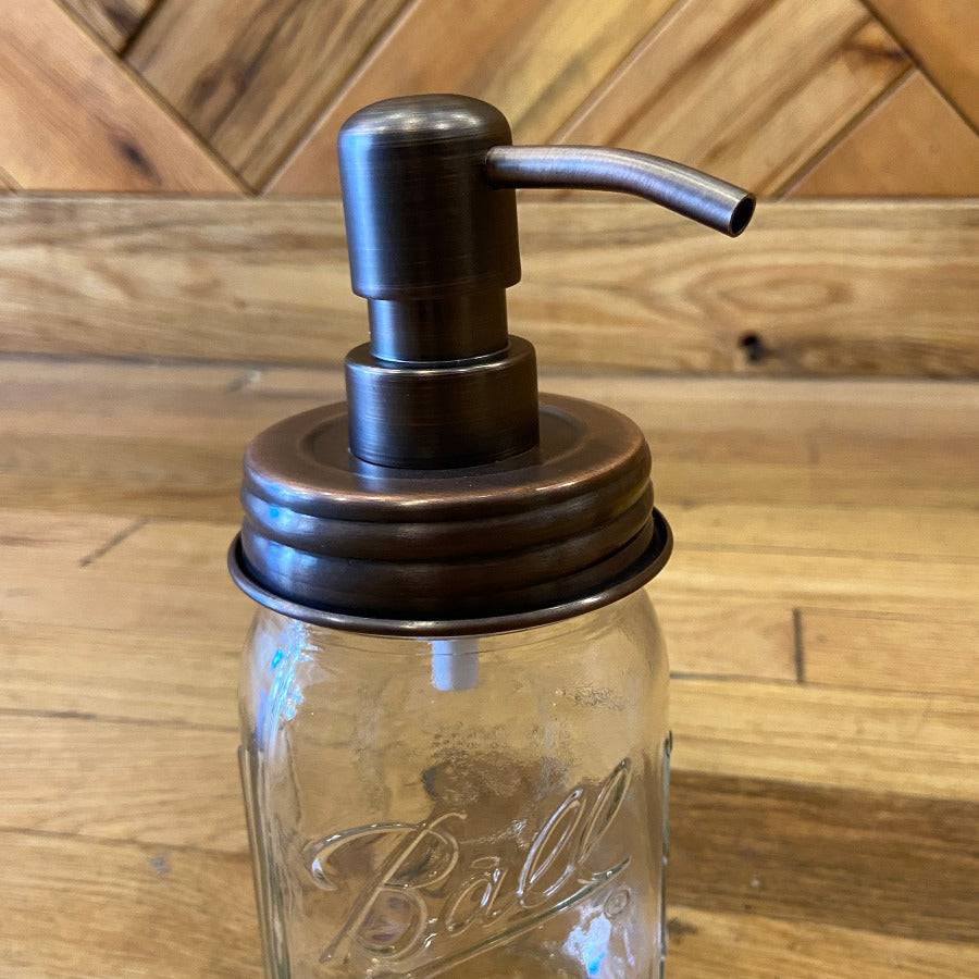 Regular mouth mason jar soap and lotion pump by One Dream Design, with a clear plastic pump and metal lid for easy dispensing.