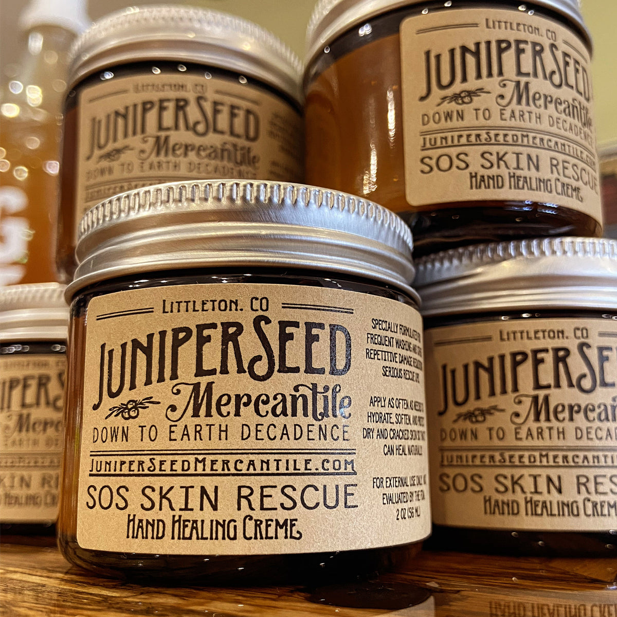 Juniperseed Mercantile SOS Skin Rescue Healing Hand Cream tube showing natural ingredients and soothing texture.