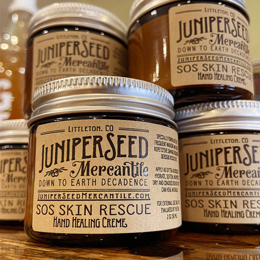 Juniperseed Mercantile SOS Skin Rescue Healing Hand Cream tube showing natural ingredients and soothing texture.