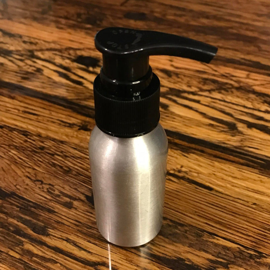 Aluminum bottles with lotion, soap, and fine mist spray pumps by OTB Refills, displayed with different pump attachments.