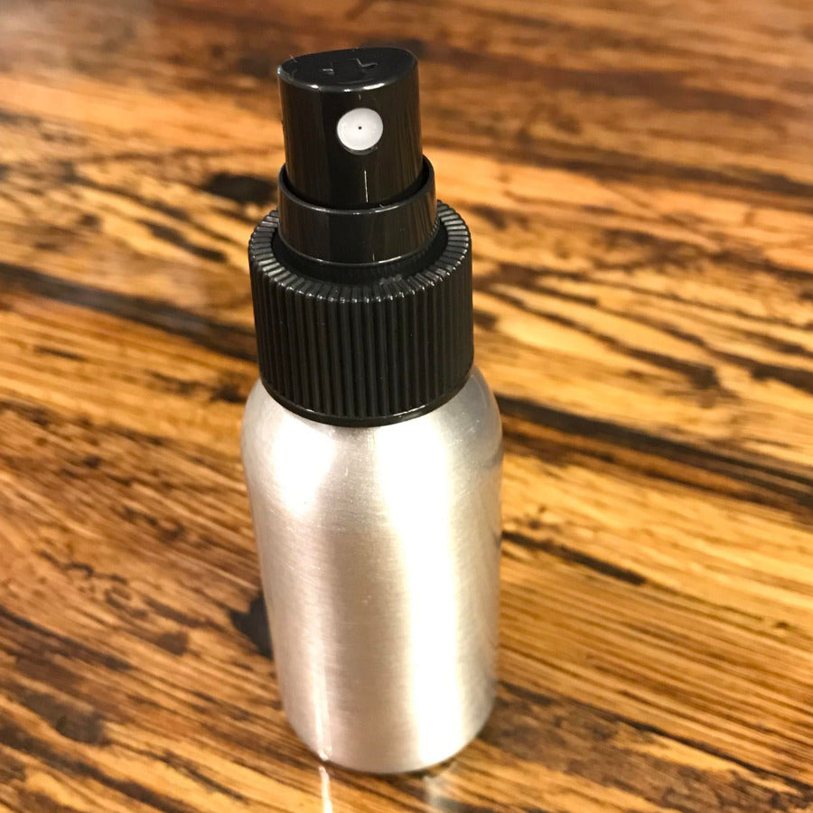 Aluminum bottles with lotion, soap, and fine mist sprayers from OTB Refills, showcasing sleek reusable containers with pumps.