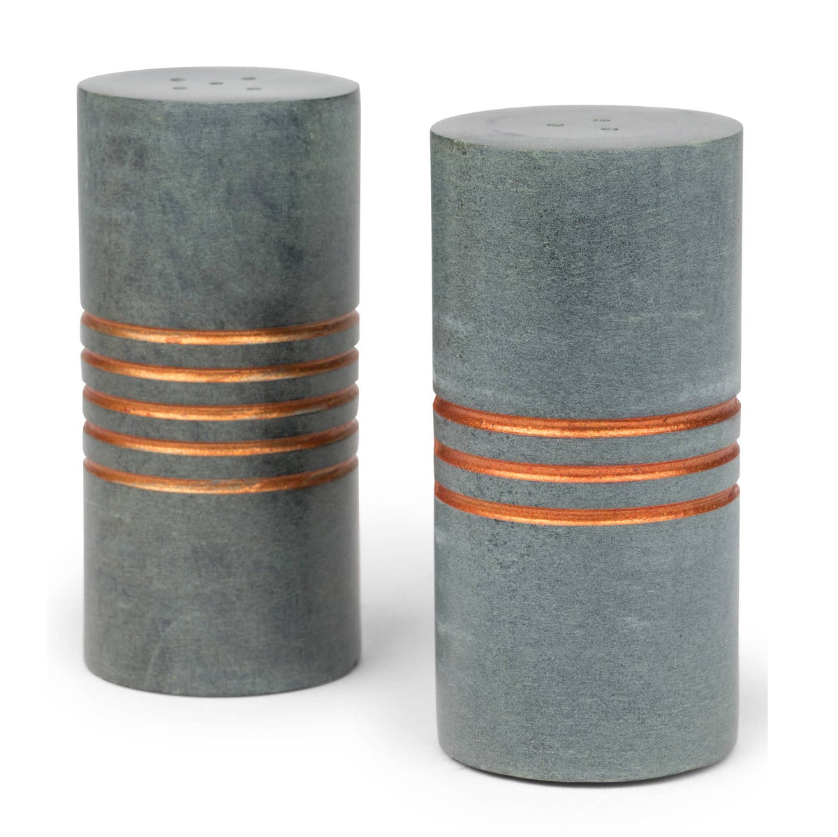 Salt and pepper stone shakers with carved patterns by Ten Thousand Villages, showcasing a rustic, handcrafted design.