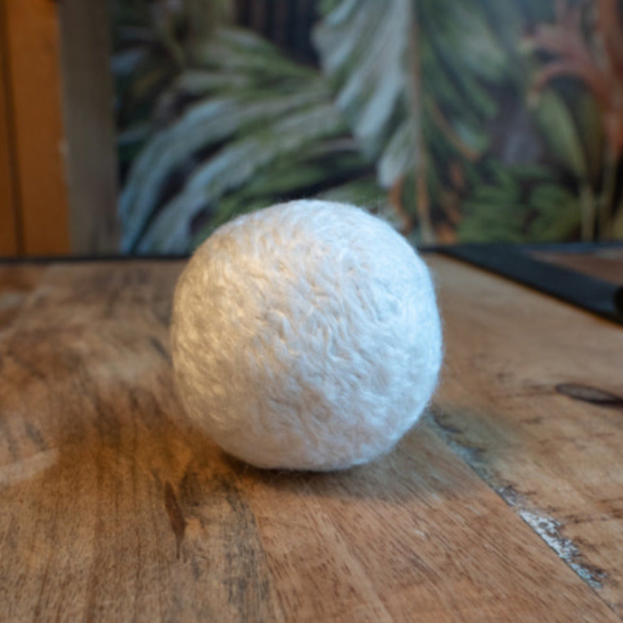 White bamboo dryer ball from Dragonfly, vegan bamboo dryer ball designed to soften laundry naturally.