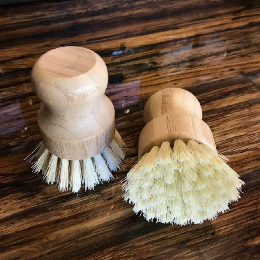 Bamboo dishwashing brush with a palm-held design from OTB Refills, featuring a natural bamboo handle and scrub bristles.