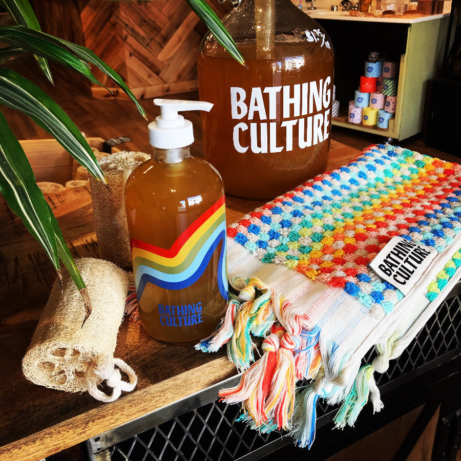 Bathing Culture Mind & Body Wash in a 16 oz glass bottle, featuring a clear liquid and minimalist label design.