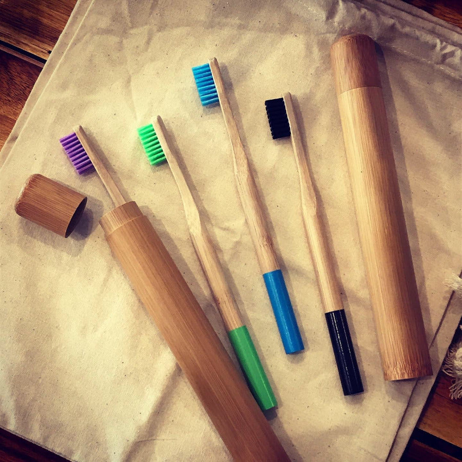 Colorful bamboo toothbrushes from OTB Refills with soft bristles, displayed in a natural setting.