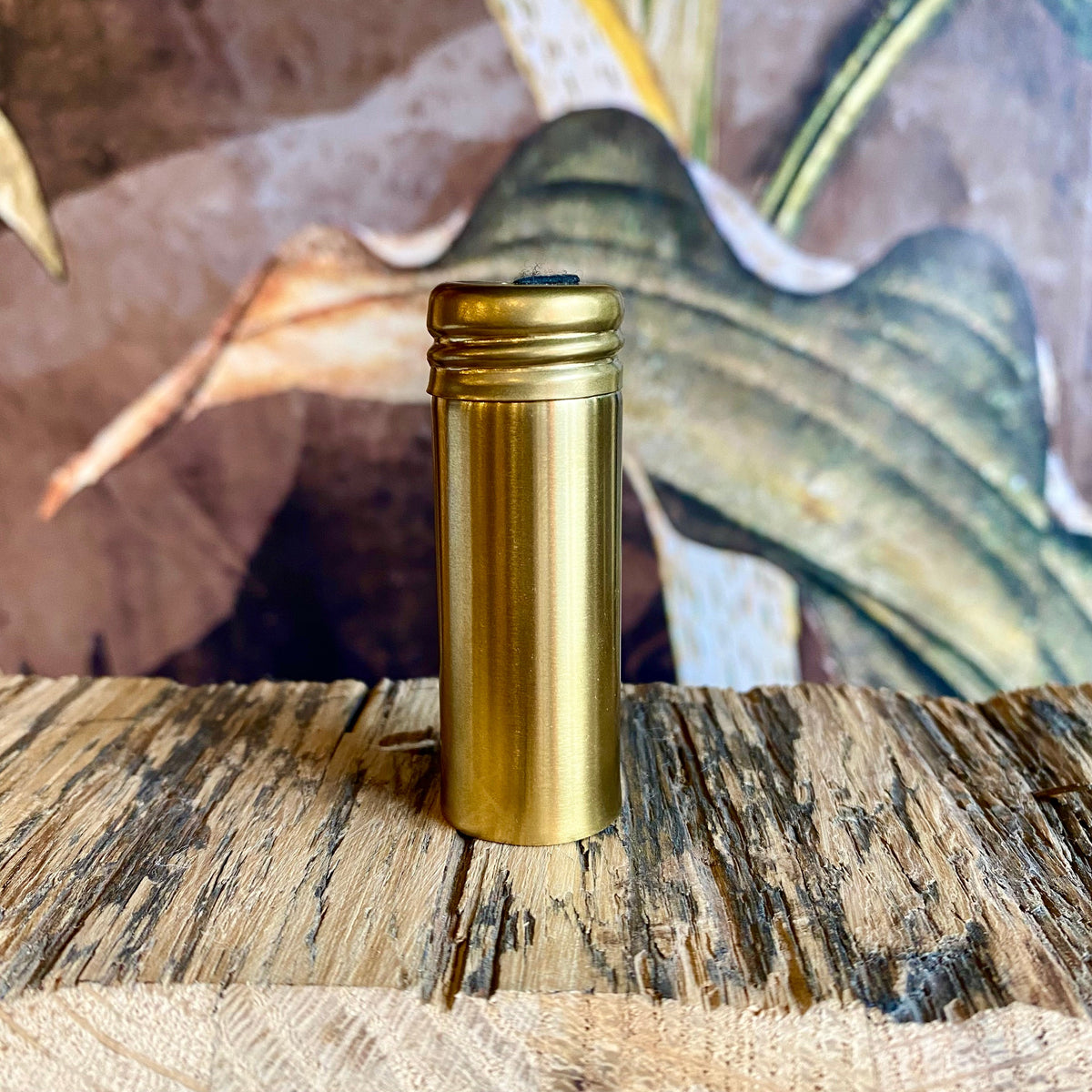 Refillable floss container by OTB Refills in sleek steel and gold, compact design for easy dental floss storage.