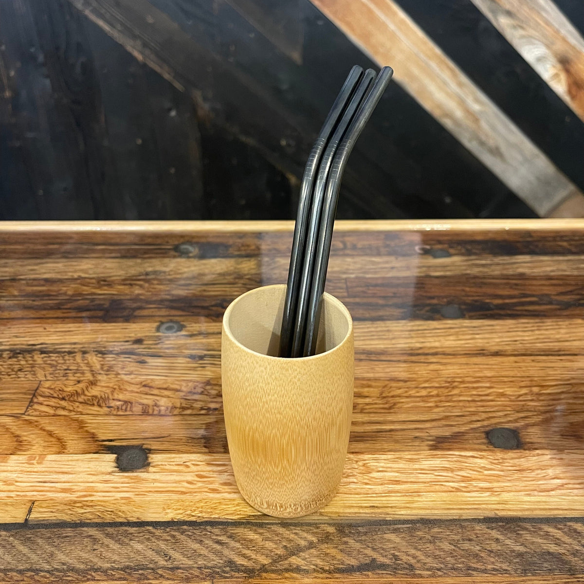 Assorted bent stainless steel straws by OTB Refills, showcasing shiny, reusable drinking straws in various colors on a white background.