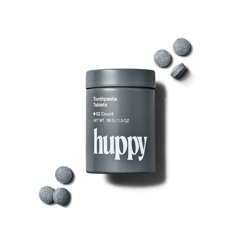 Huppy charcoal toothpaste tablets in a tin, 62 tablets, natural oral care with activated charcoal for teeth whitening and fresh breath.