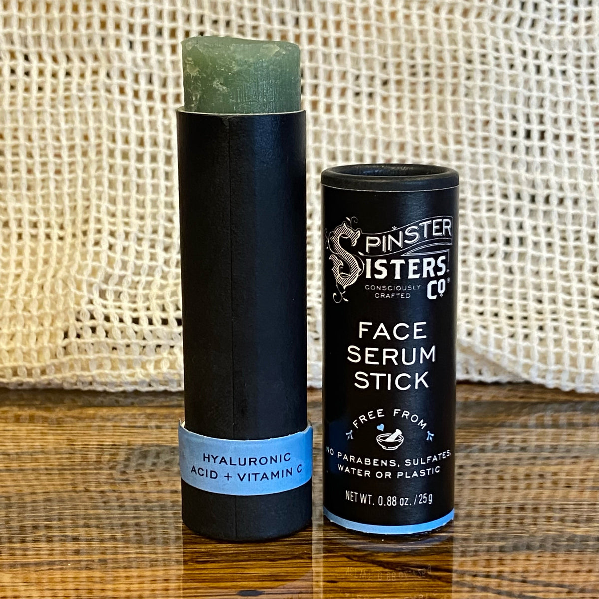 Spinster Sisters Face Serum Stick with hyaluronic acid and vitamin C, showing the portable skincare product with clear labeling