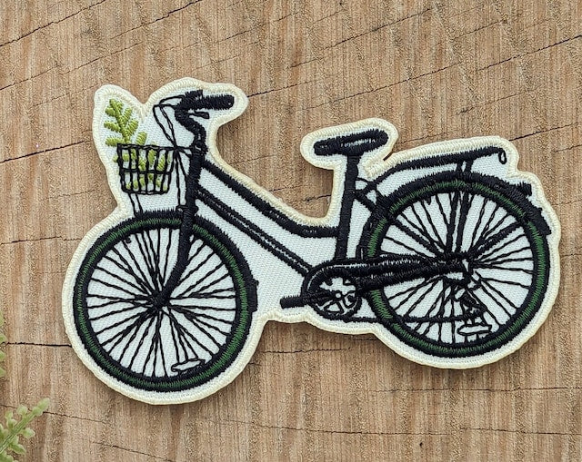 ilikesara patches displayed on a surface, showcasing colorful fabric design and embroidered details for decorative use.