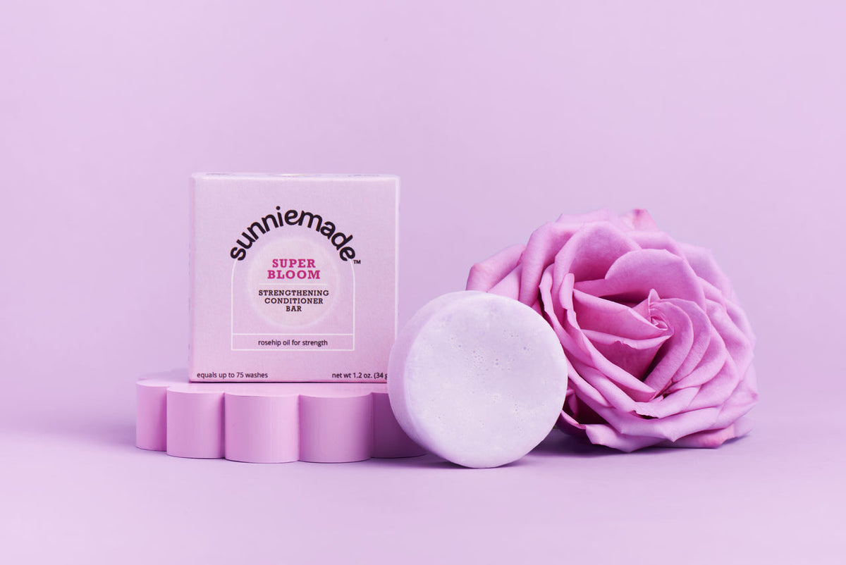 SunnyMade conditioner bar shown with a sleek, eco-friendly packaging and the bar's smooth, natural surface.