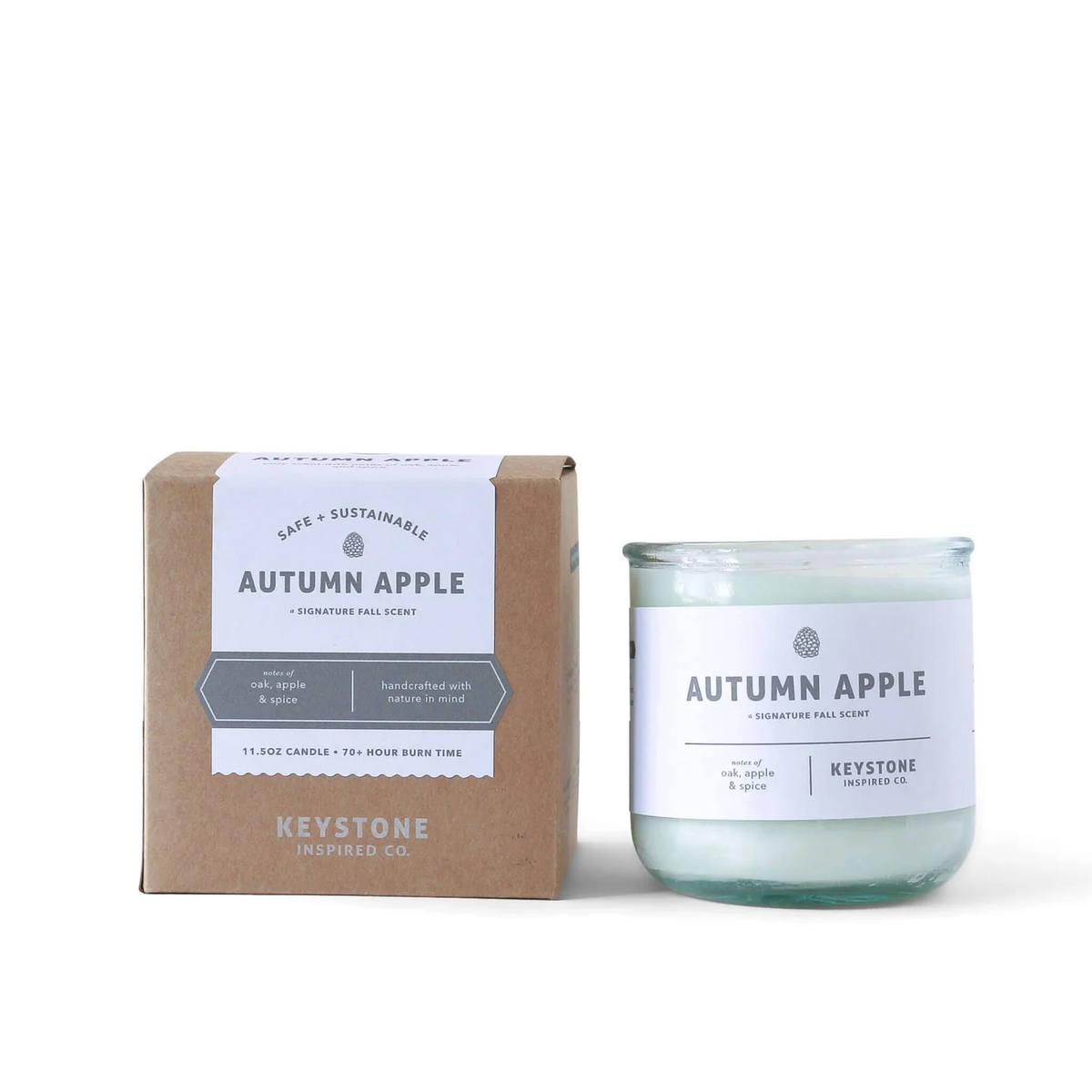 11.5 oz soy candle in a clear glass container by Keystone Inspired, showcasing a lit candle with a cozy, warm glow.
