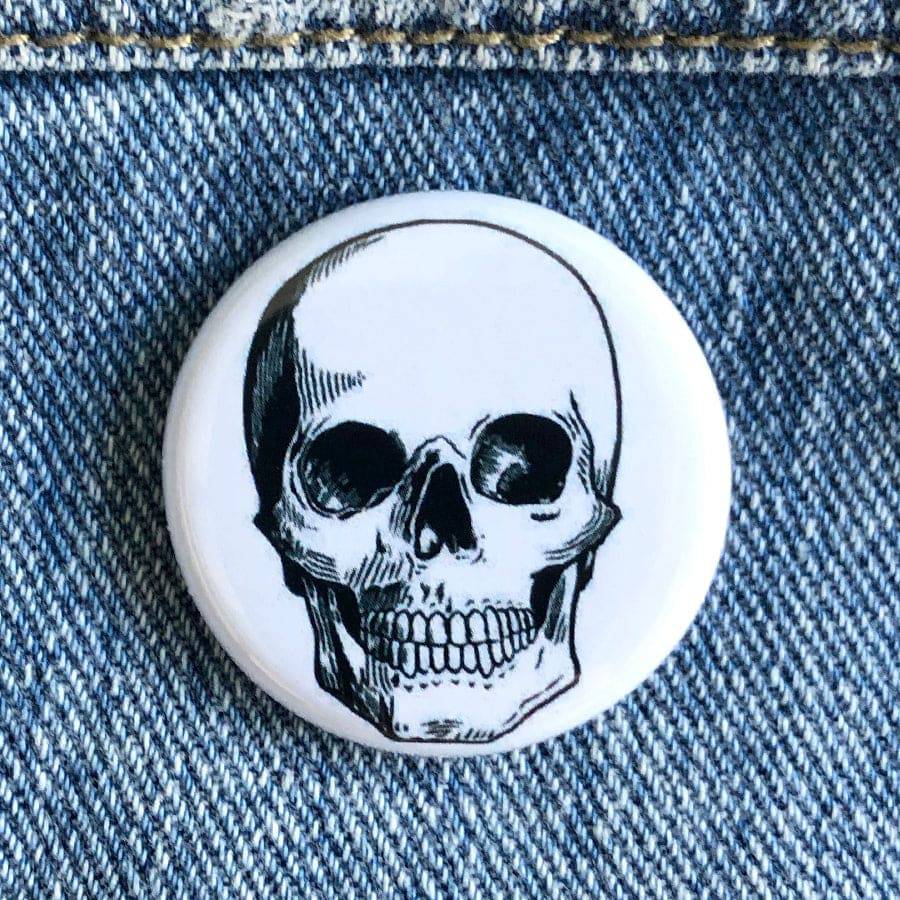 Counter Couture button showing a decorative, round fabric-covered button with intricate stitching details.