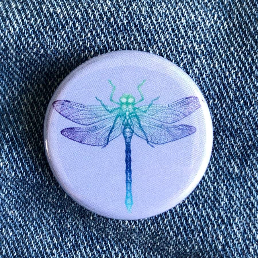 Counter Couture button with decorative design, close-up view showing intricate details and vibrant colors.