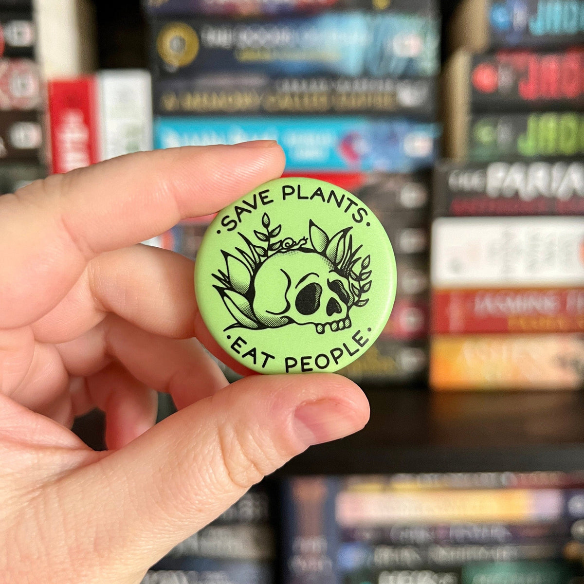 Black mourning breath button pin with metallic finish, featuring a detailed design, worn as a somber accessory.