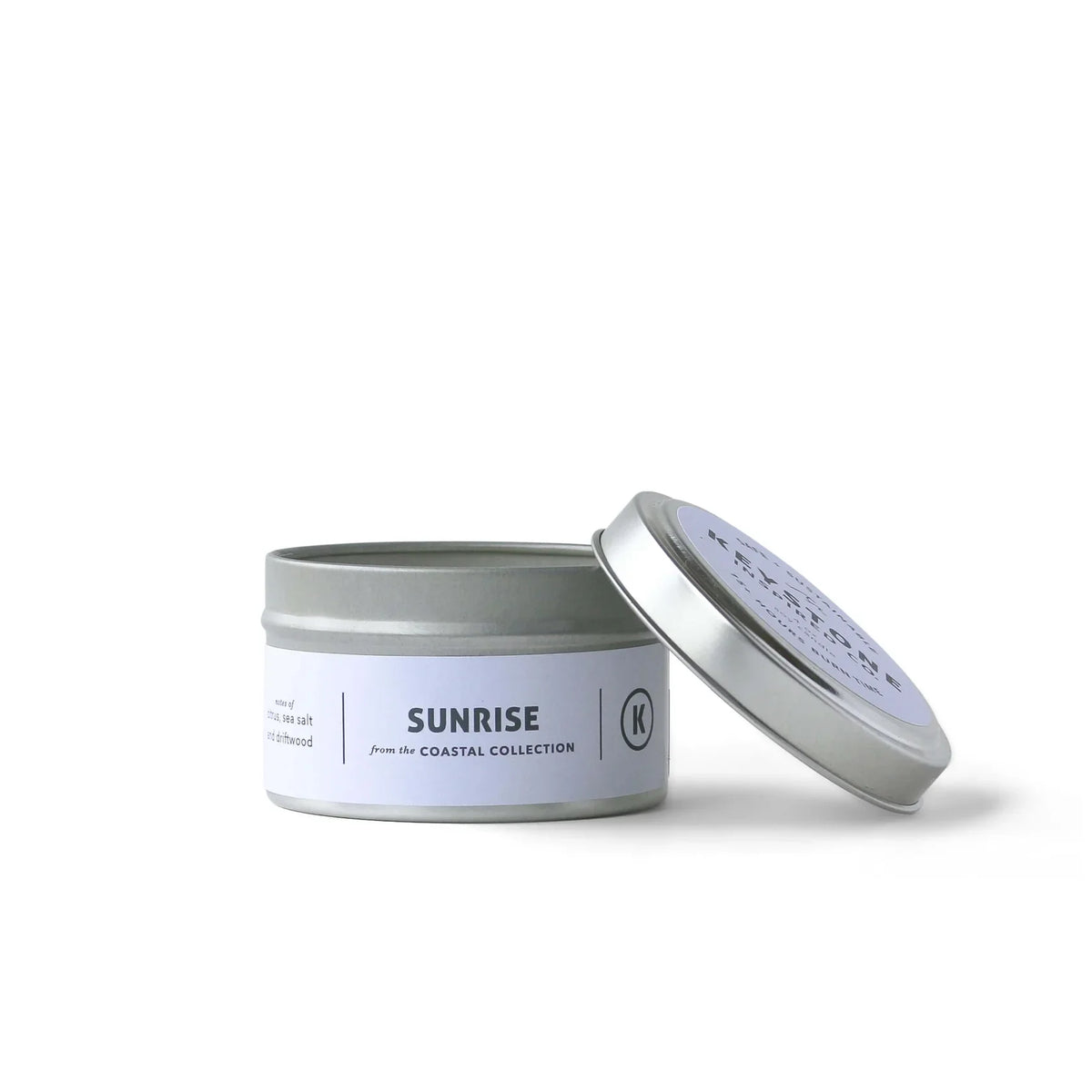 Four-ounce soy candles in a travel tin by Keystone Inspired, featuring a cozy design and natural wax finish.