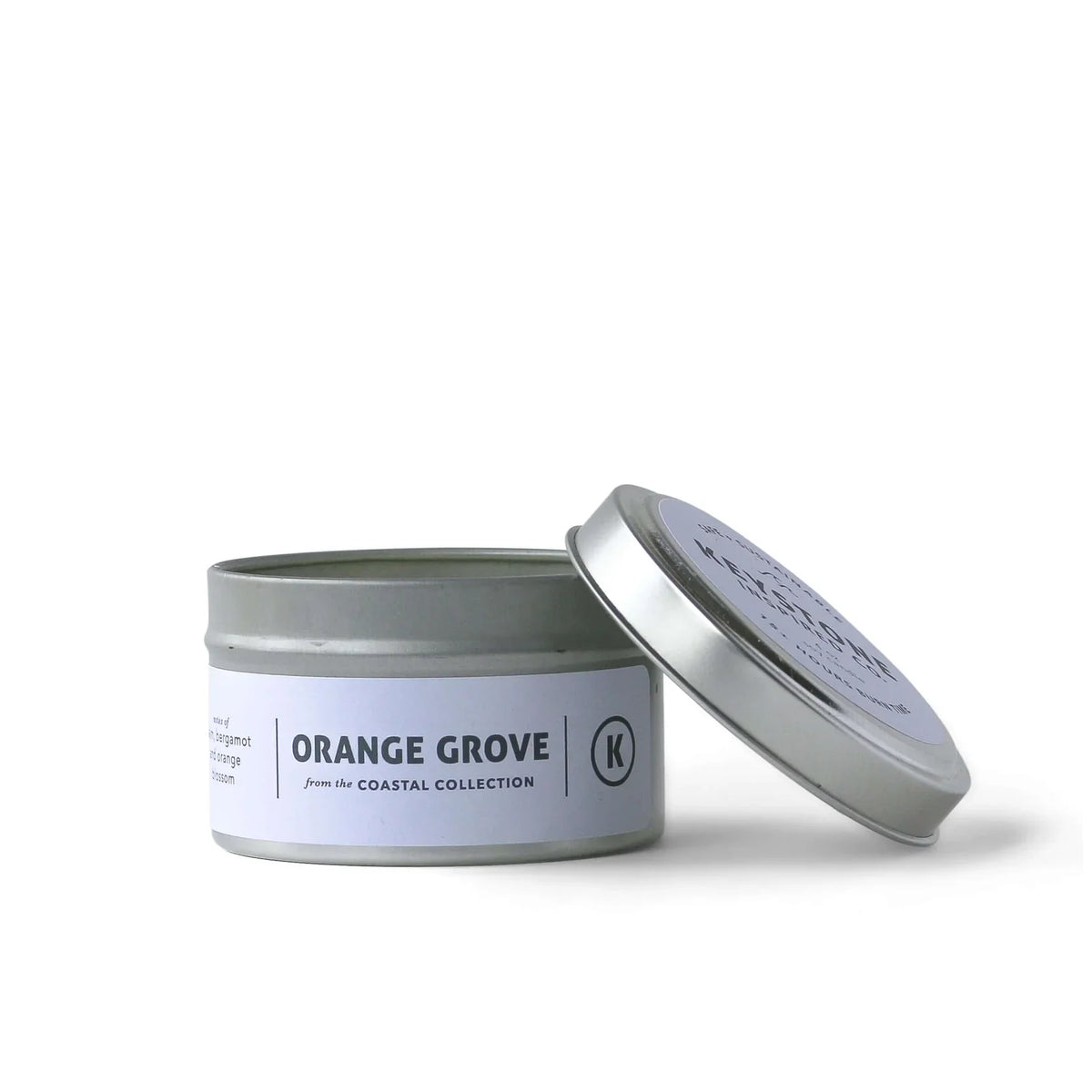 4 oz Keystone Inspired soy candle in a travel tin with a lit wick, showcasing a cozy, warm ambiance.