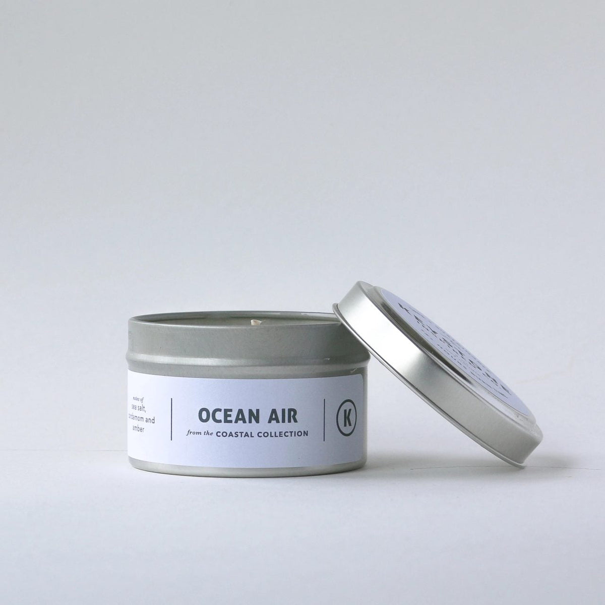 4 oz soy candles in travel tin by Keystone Inspired, showing a cozy, scented candle with a wooden wick and minimalist packaging.