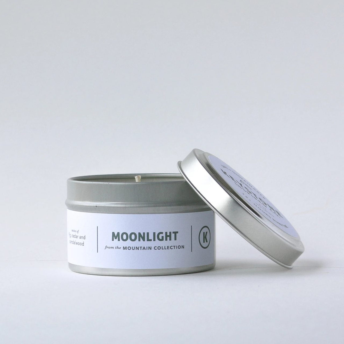 Keystone Inspired 4 oz soy candles in travel tins with flickering flame and scented wax, perfect for portable relaxation.