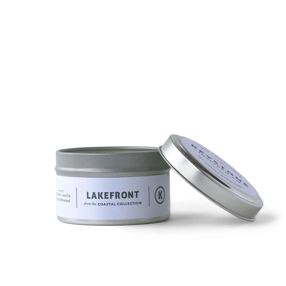 4 oz soy candle in a travel tin from Keystone Inspired, with a rustic label and a lit wick for cozy ambiance.