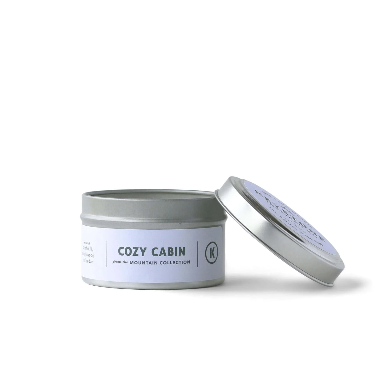 4 oz soy candles in a travel tin by Keystone Inspired, showing the candle with a lit wick and minimalist design.