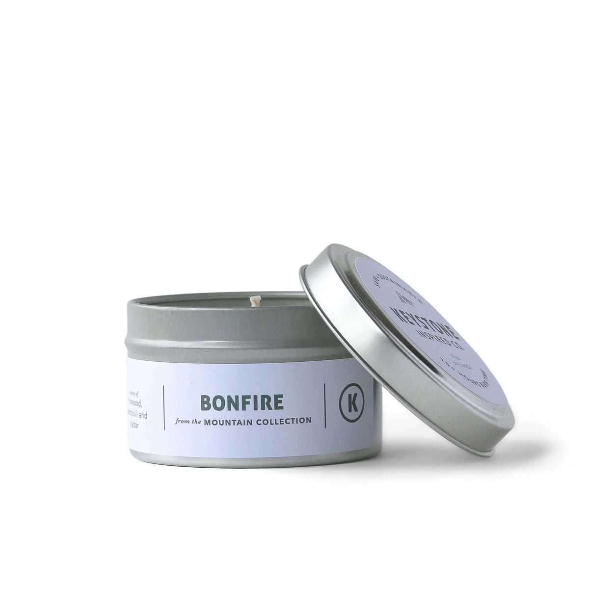 4 oz Keystone Inspired soy candles in a travel tin, featuring a cozy design and natural wax for aromatic home ambiance.