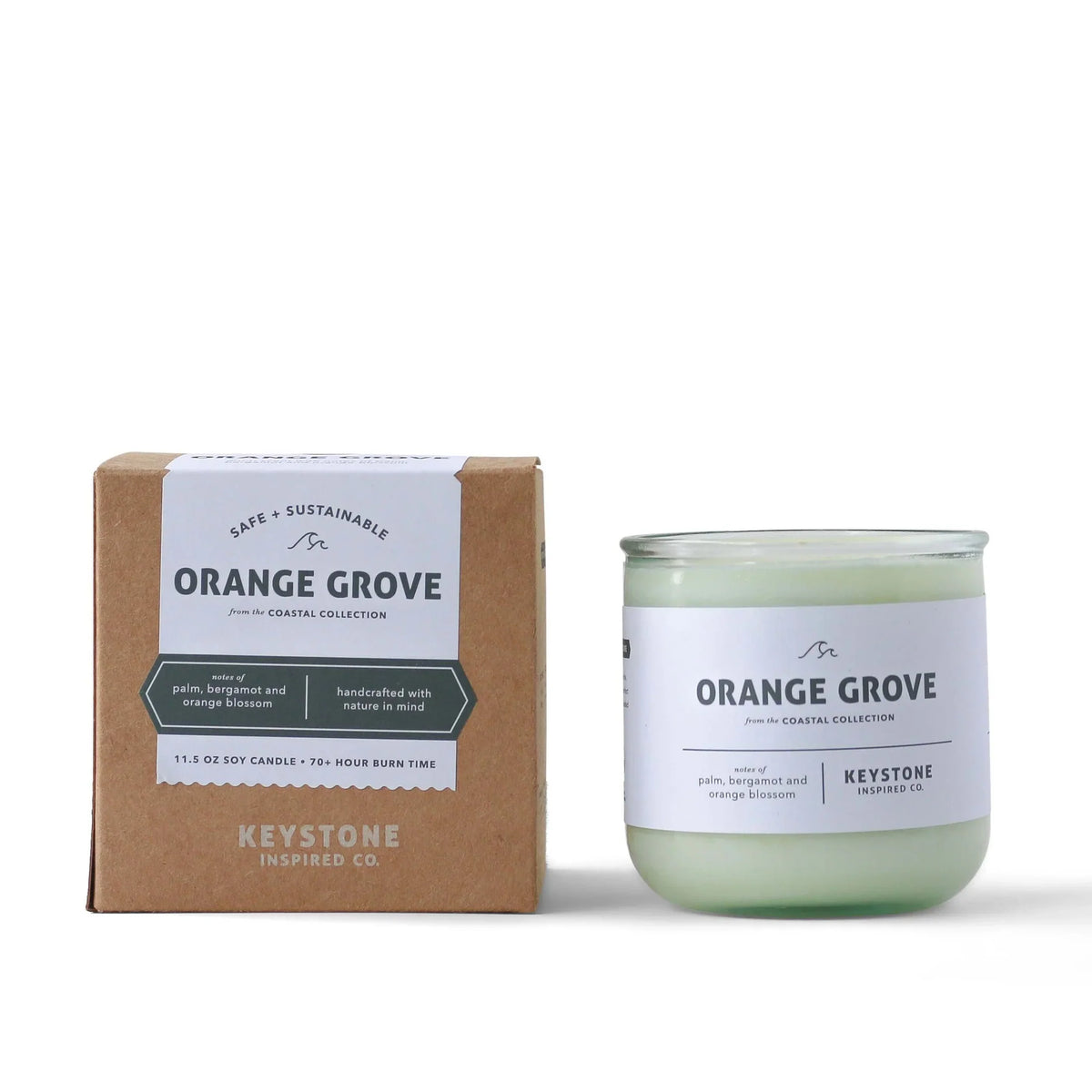 11.5 oz soy candle in clear glass jar from Keystone Inspired, with a lit wick and a cozy, relaxing ambiance.