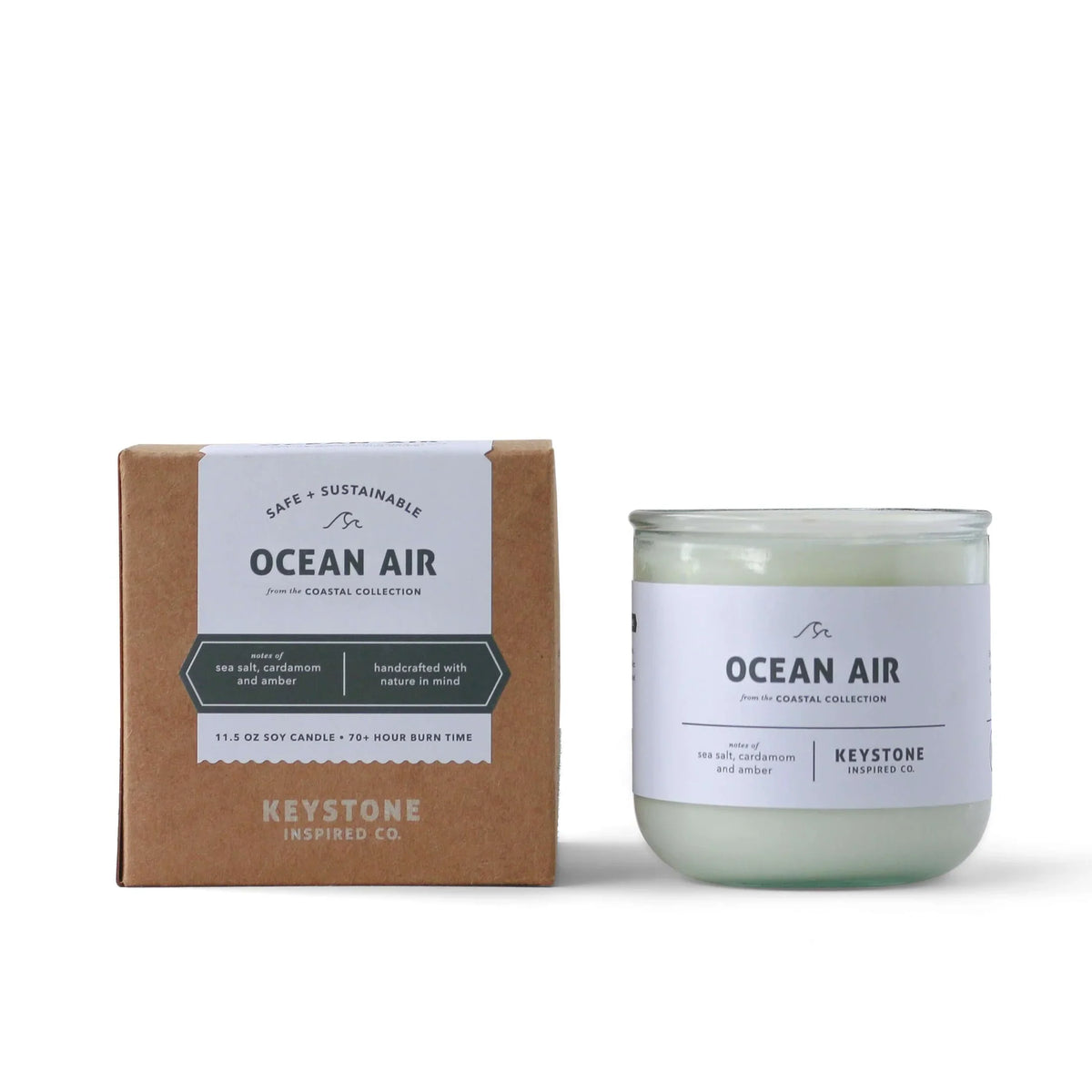 11.5 oz Keystone Inspired soy candle in a clear glass jar with a wick and wax visible inside.