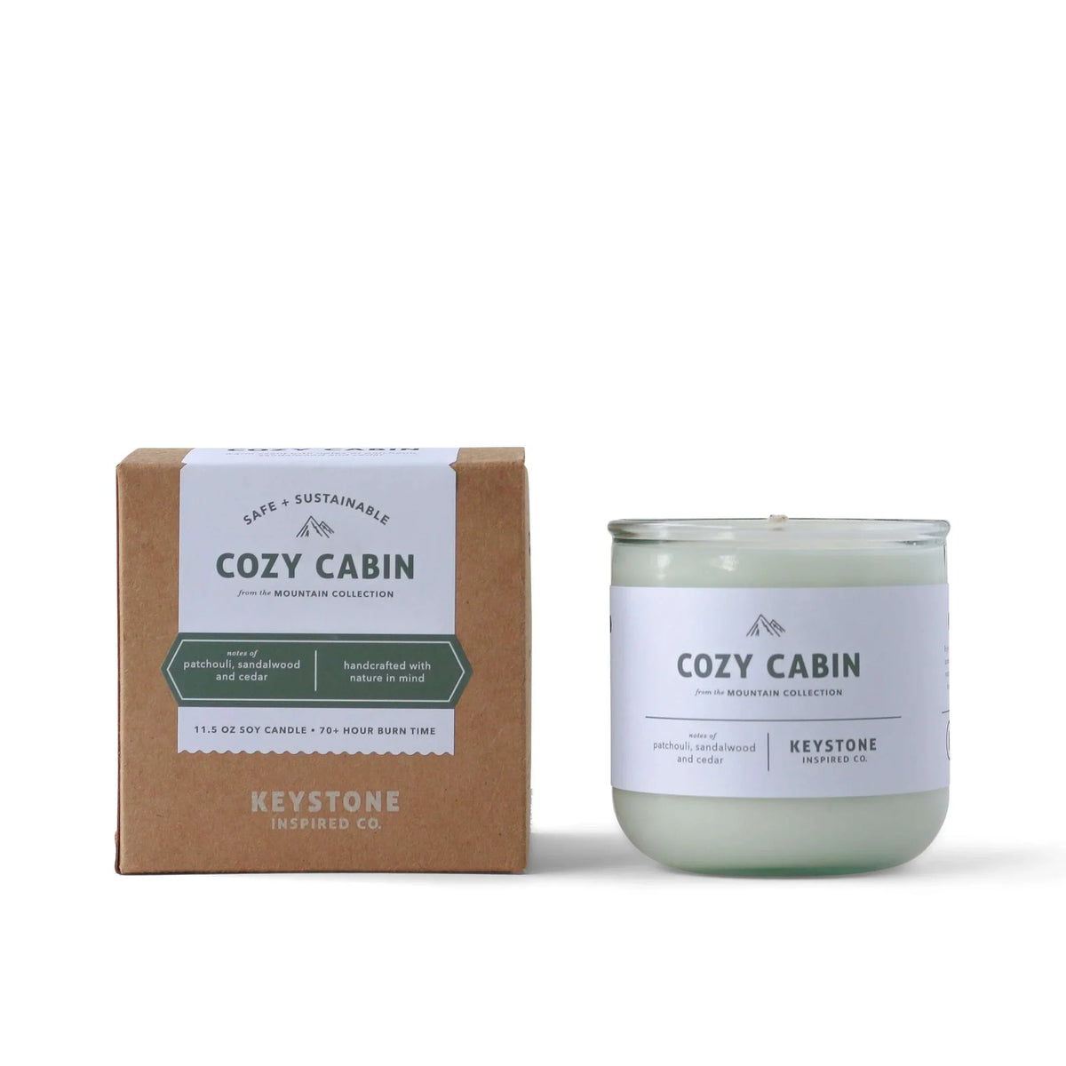 11.5 oz Keystone Inspired soy candle in a clear glass jar with a lit wick, showcasing warm candlelight and natural soy wax.