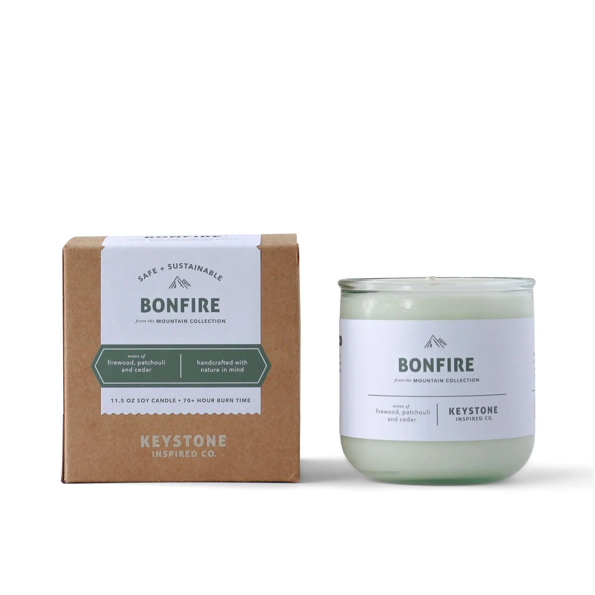 11.5 oz Keystone Inspired soy candle in a clear glass jar, with a lit wick and a soft, warm glow.