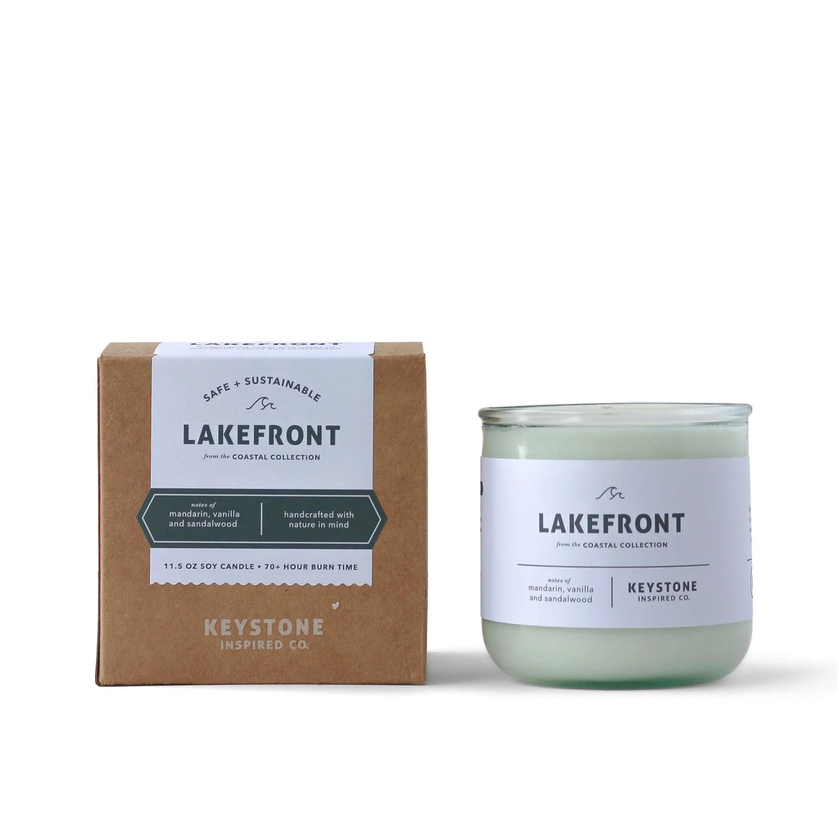 11.5 oz Keystone Inspired soy candle in a clear glass container, natural wax with a lit wick and subtle floral scent.