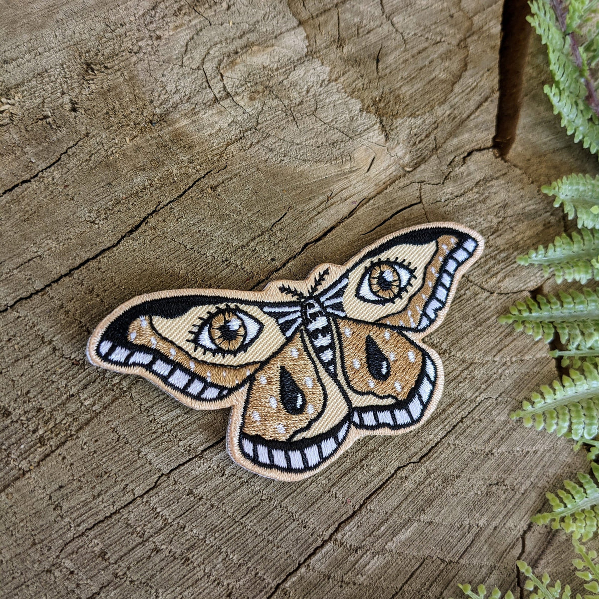 Close-up of ilikesara patches featuring colorful, decorative fabric designs on a neutral background.