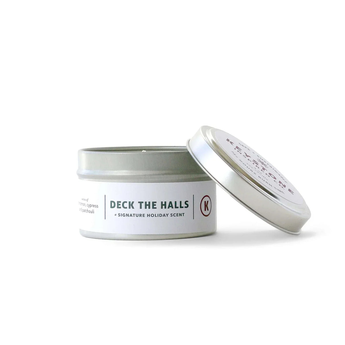 4 oz Keystone Inspired soy candle in a travel tin, showcasing a cozy, minimalist design with a lit wick for a warm ambiance.