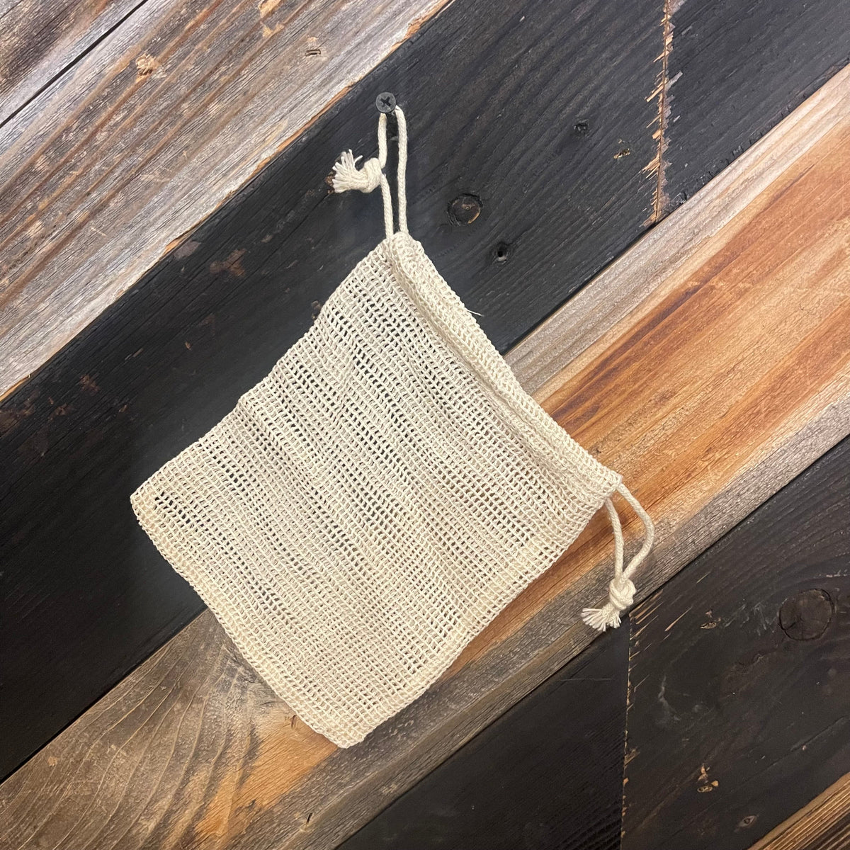 Cotton mesh bag in various sizes by OTB Refills, showing breathable fabric and multiple dimensions for versatile storage.