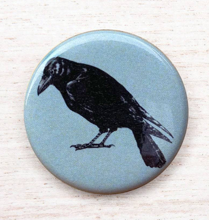 Counter Couture button with detailed design, metal finish, and decorative accents, ideal for sewing or craft projects.