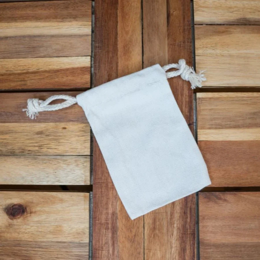 Drawstring cotton bag by OTB Refills in various sizes, showing soft fabric and adjustable closure for eco-friendly storage.