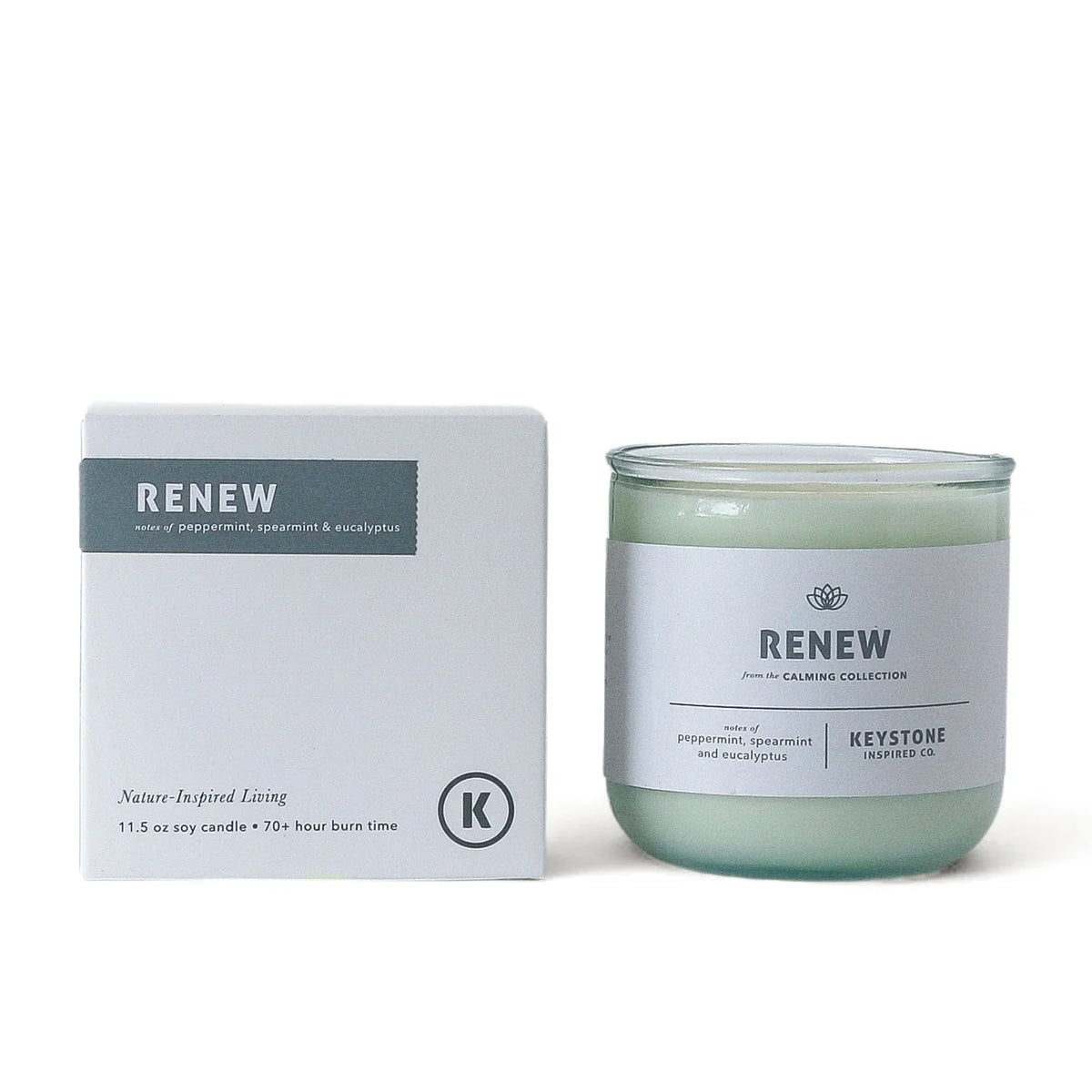 11.5 oz Keystone Inspired soy candle in a clear glass jar, with a lit wick and natural wax, perfect for home ambiance.