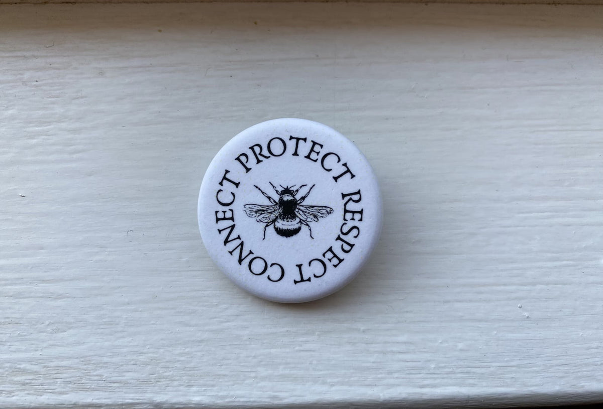 Off the Bottle Refill Shop Freethinker Paper Co buttons featuring colorful, round designs on a white background.