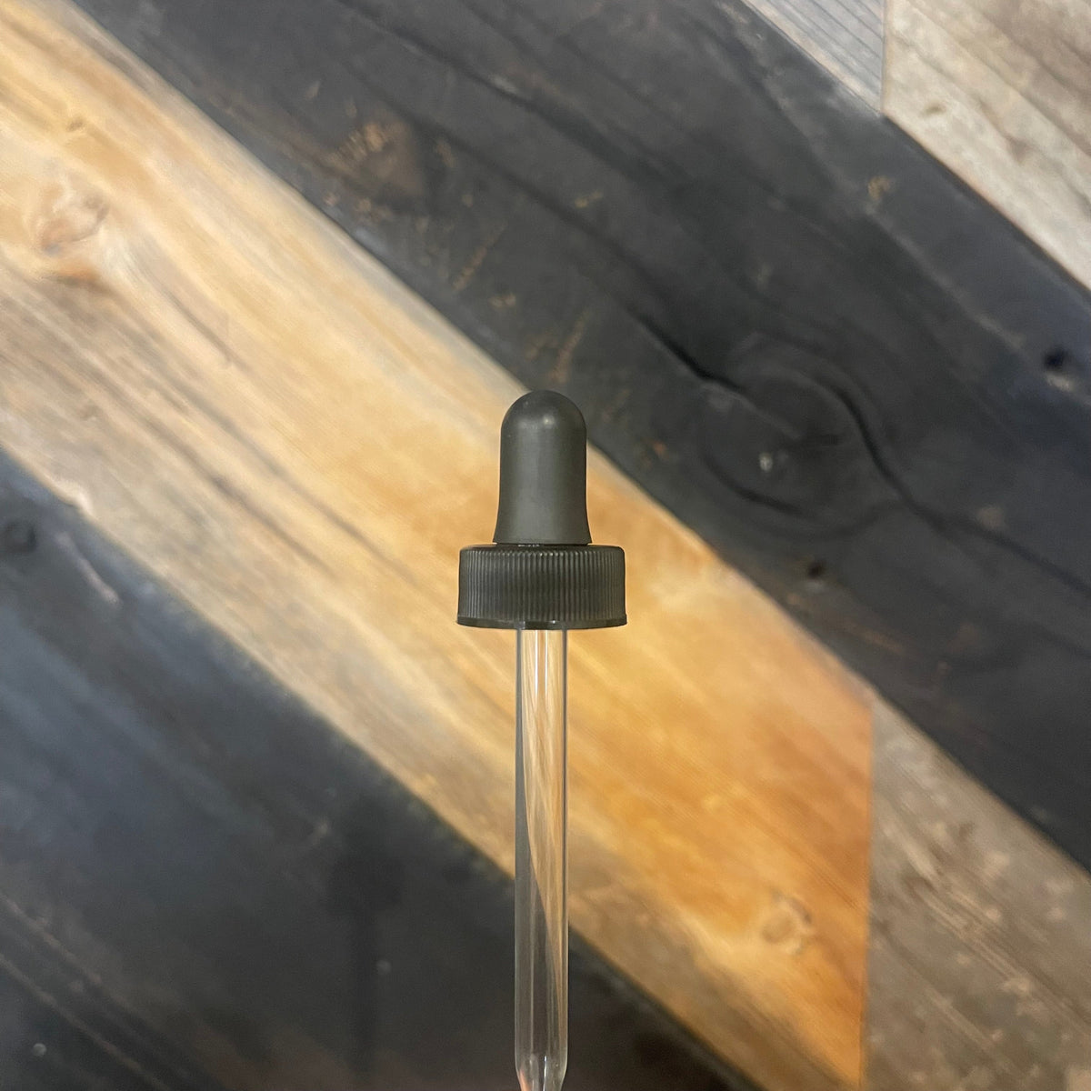 Glass dropper for 2oz glass bottles by Premium Vials, showing the dropper with a clear glass pipette and black rubber bulb.