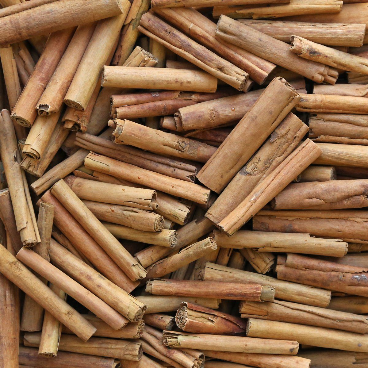 Organic Zeylonicum cinnamon sticks from Essential Organics, showing whole aromatic cinnamon sticks on a rustic surface.