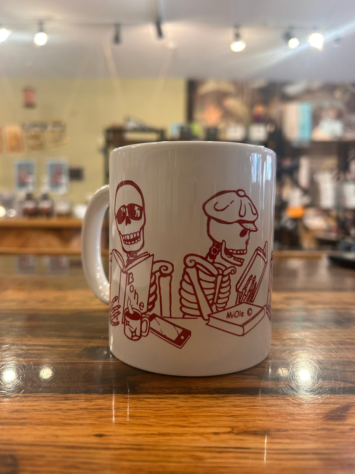 MiOle coffee mug with a sleek white ceramic design, featuring a smooth surface and comfortable handle.