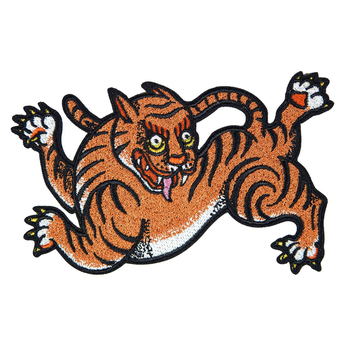 Close-up of Stuntin’ Goods patches featuring bold embroidered designs on a fabric background.