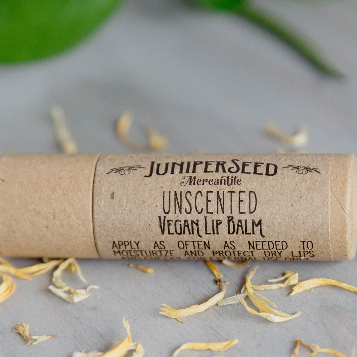 Juniperseed Mercantile Lip Balms in various flavors, featuring sleek packaging and natural ingredients.